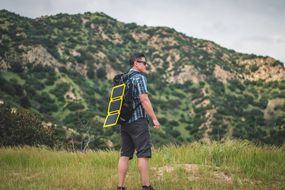 Man with Portable Solar Charger Panel