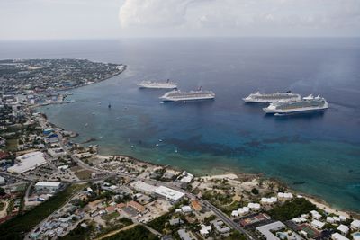 Four cruise ships anchored offshore of Georgetown Harbor, Grand Cayman“width=