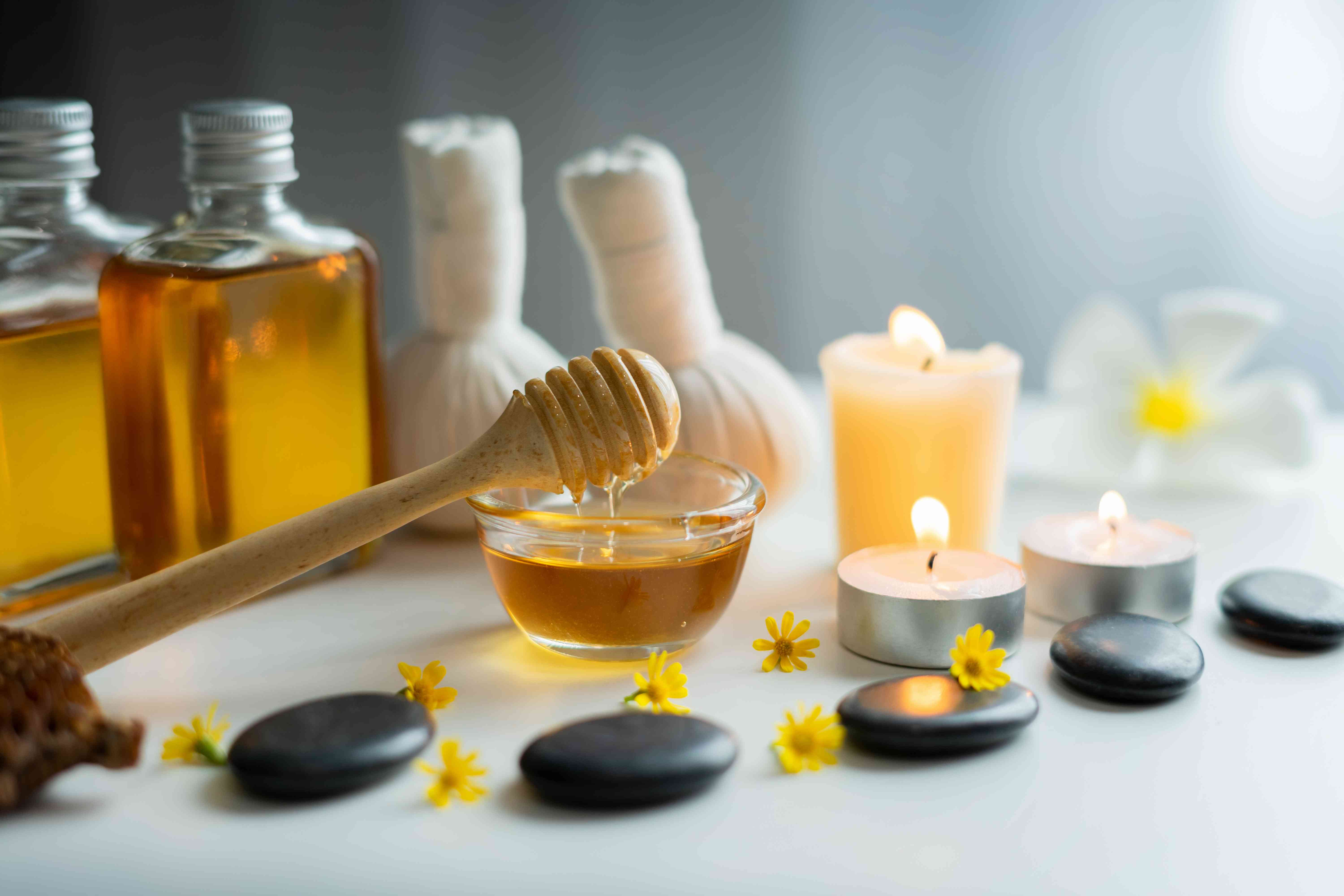 Closeup on honey spa therapy ingredients and salt spa objects