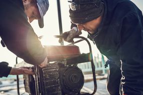 Men turning on a generator