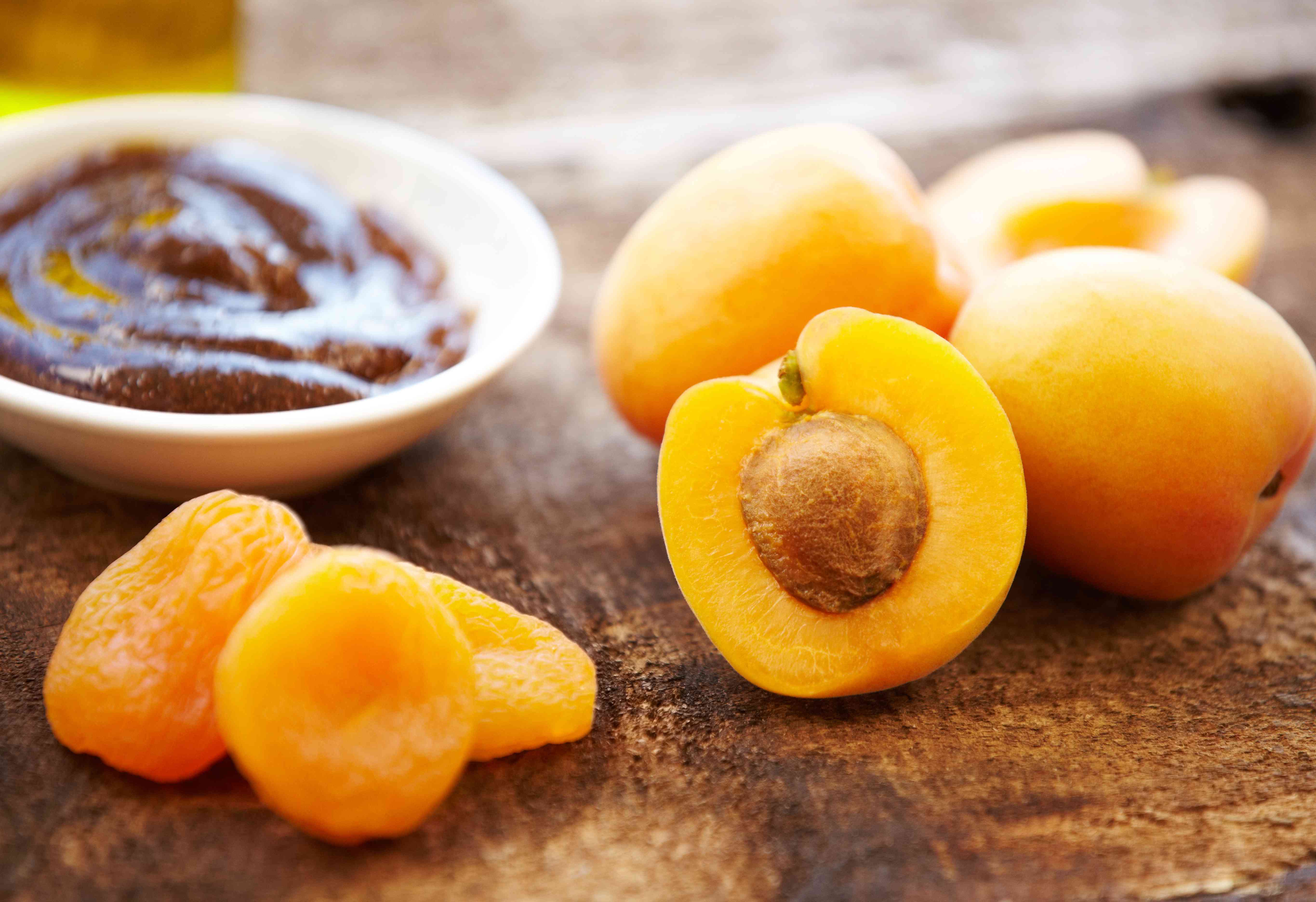 Organic skincare, salt scrub in a bowl, fresh apricots