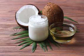 coconut oil and coconuts, palm branches close up